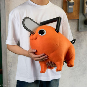 Person holding the Pochita life-size plush doll close to their chest in a lifestyle setting.