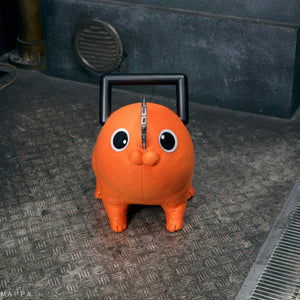 Frontal head-on view of the Pochita life-size plush doll sitting on industrial metal flooring.