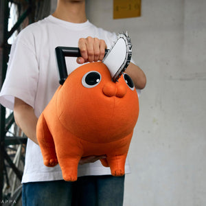 Person holding the Pochita life-size plush doll under both arms to show its 60cm scale.