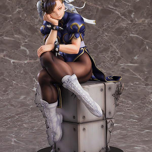 Front-facing view of the Chun-Li scale figure sitting on a grey industrial-style block base.