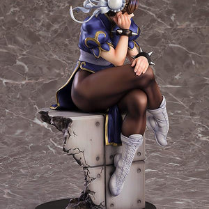 Three-quarter rear view of Chun-Li sitting, emphasizing the shadows and highlights of the sculpt.