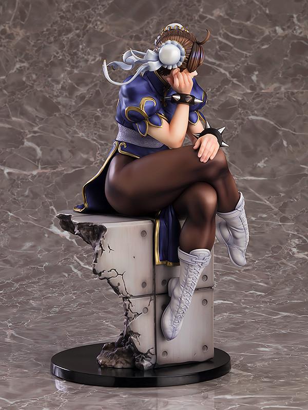 Three-quarter rear view of Chun-Li sitting, emphasizing the shadows and highlights of the sculpt.