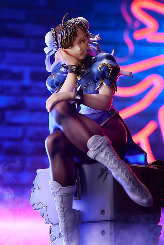 Low angle shot of Chun-Li figure under purple neon lights, highlighting her pensive expression.