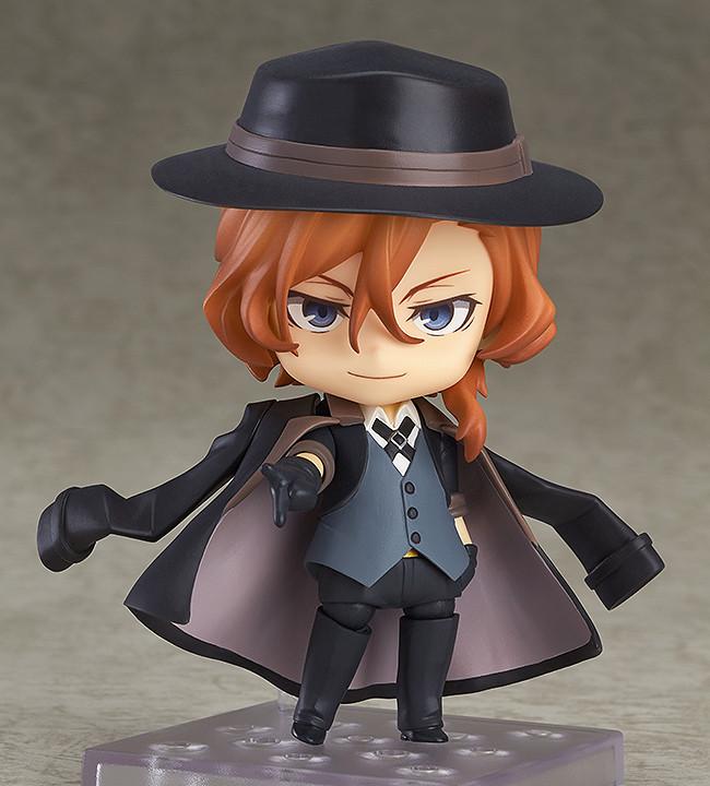 Chuya Nakahara Nendoroid figure standing on a clear display base with his signature black coat draped over his shoulders.