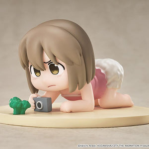 Studio display view of the non-articulated Niikura Mini Memory collectible anime figure crawling with a toy camera and miniature broccoli.