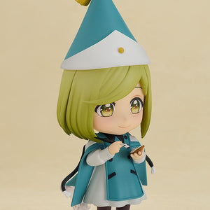 Three-quarter view of the Coco Nendoroid action figure holding her tiny ink wand brush and palm quire notebook accessories in her hands.