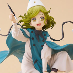 Close-up studio shot of the Coco figure highlighting her joyful expression, large golden eyes, and the detailing on her double-breasted robe.