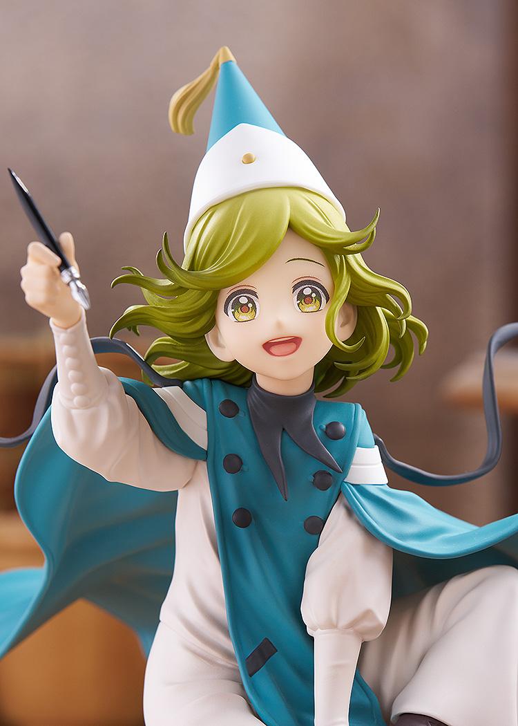 Detailed portrait shot of the Good Smile Company Coco figure, focusing on her cheerful smiling face, wavy green hair, and signature pointed white witch hat.
