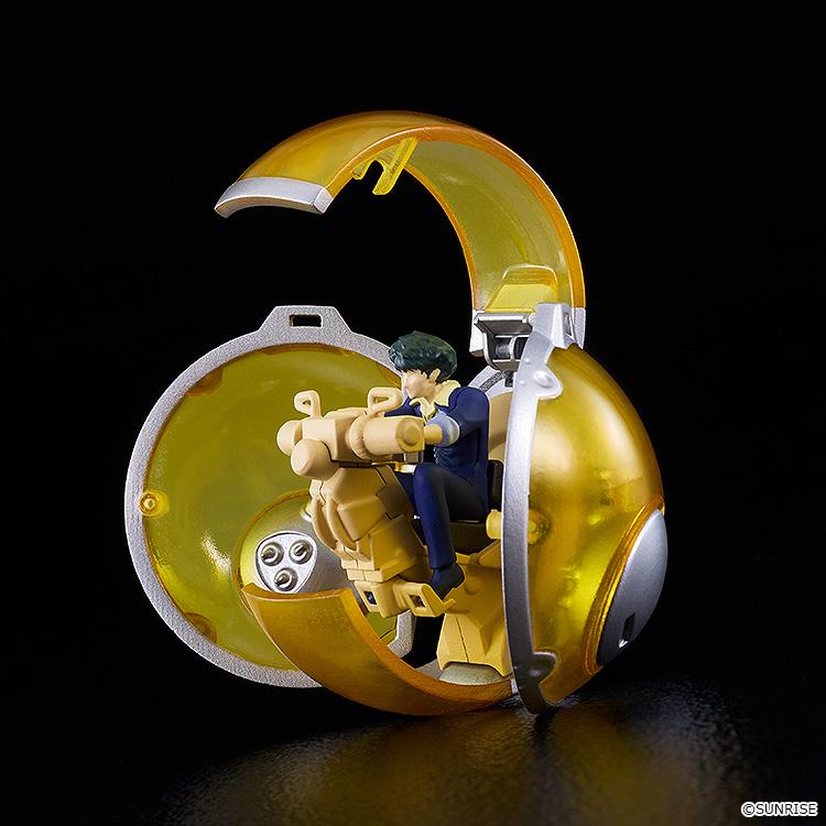 Close-up view of the open yellow glass Mono-pod cockpit unit with a miniature seated Spike Spiegel figure inside the controls.