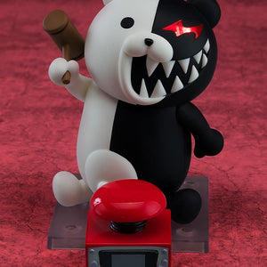 Nendoroid Monokuma figure holding the hammer accessory, positioned next to the large red punishment button accessory.