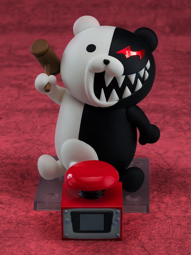Nendoroid Monokuma figure holding the hammer accessory, positioned next to the large red punishment button accessory.
