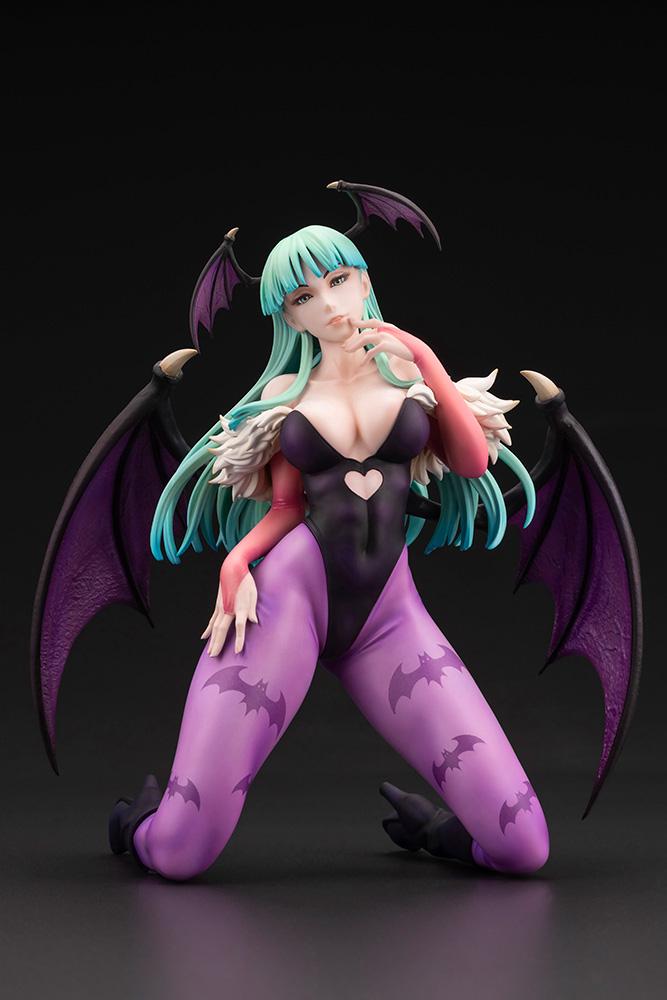 Full front view of the Kotobukiya Darkstalkers Morrigan Aensland 1/7 scale figure kneeling against a dark studio background.