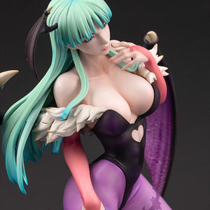 High-angle close-up shot capturing the delicate facial features, head wings, and chest detail of the Morrigan figure.