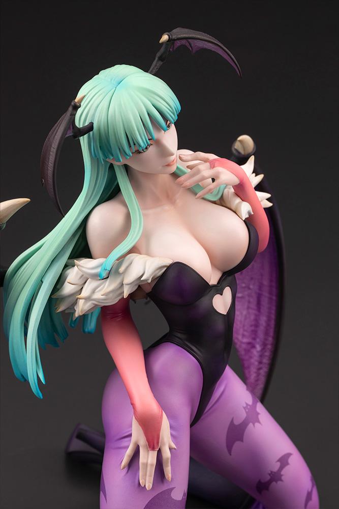 High-angle close-up shot capturing the delicate facial features, head wings, and chest detail of the Morrigan figure.