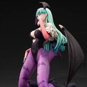 Side profile view of the Morrigan Aensland succubus figure kneeling with outstretched bat wings and green hair.