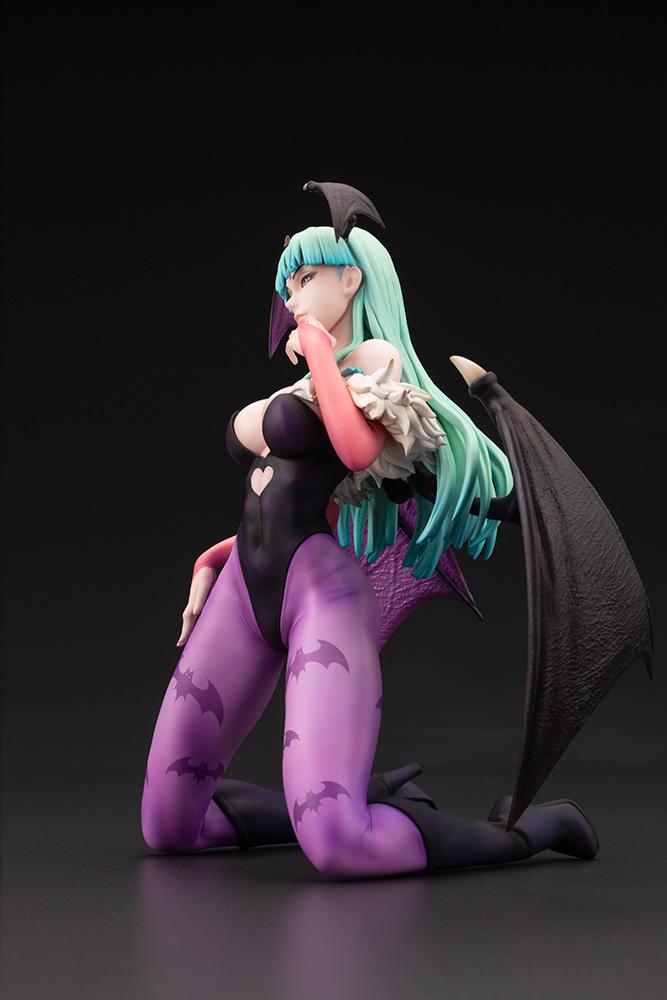 Side profile view of the Morrigan Aensland succubus figure kneeling with outstretched bat wings and green hair.