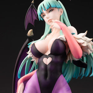 Front close-up portrait of the Morrigan Aensland figure showing facial features, green hair, and fur collar detail.