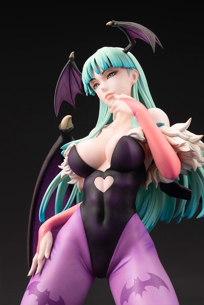 Front close-up portrait of the Morrigan Aensland figure showing facial features, green hair, and fur collar detail.