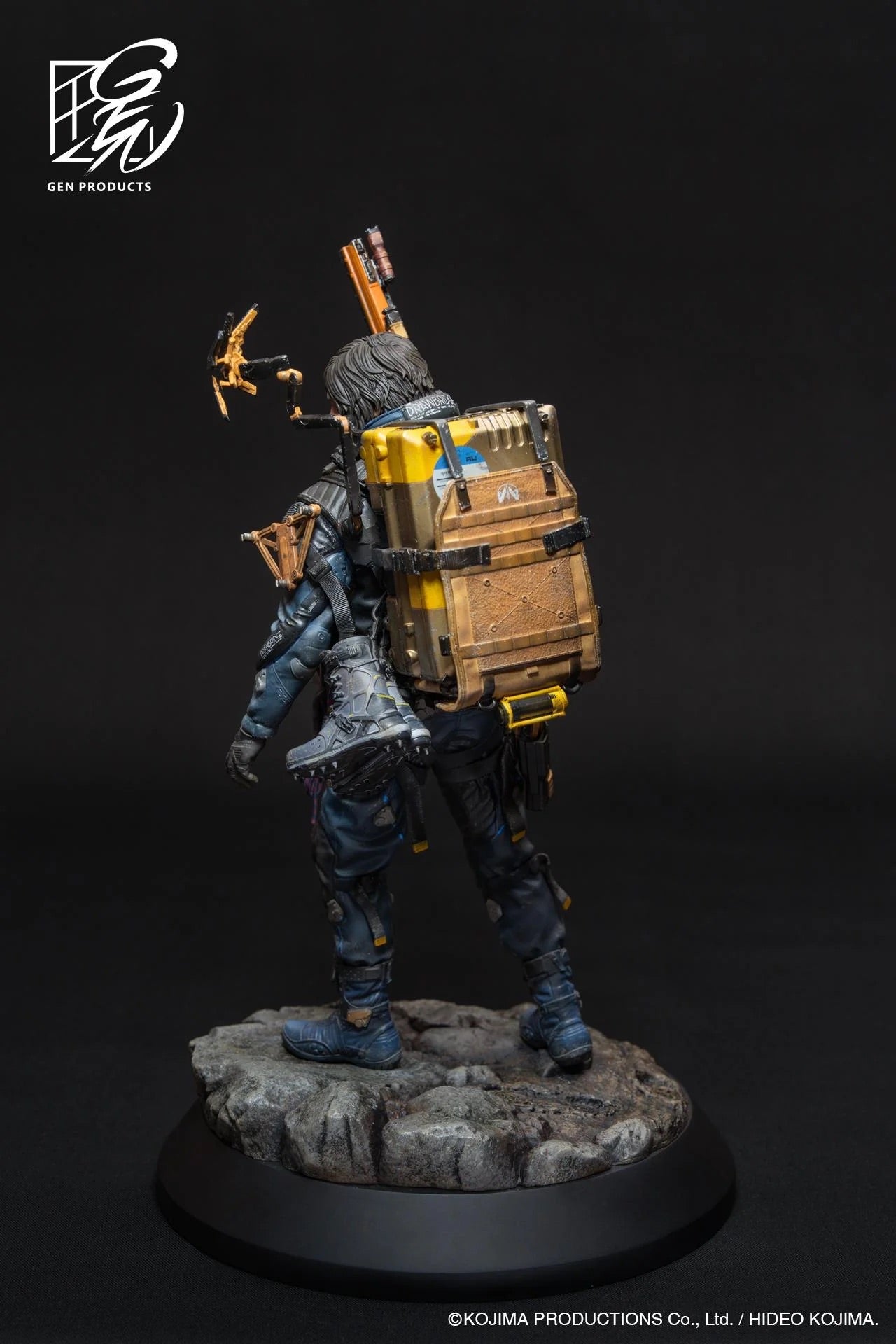 Back view of the Sam figure, showcasing the intricate cargo stack and delivery equipment on his backpack and the detailed base.