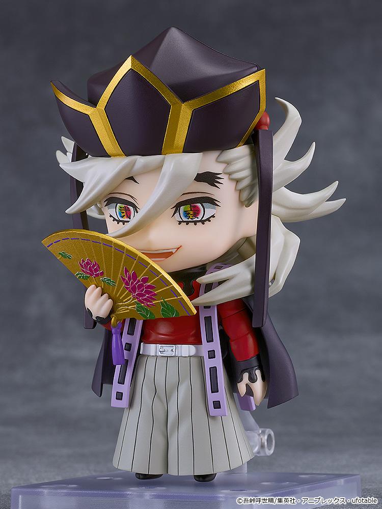 Three-quarter pose of Doma Nendoroid figure holding open golden folding fan and displaying rainbow demon eyes.