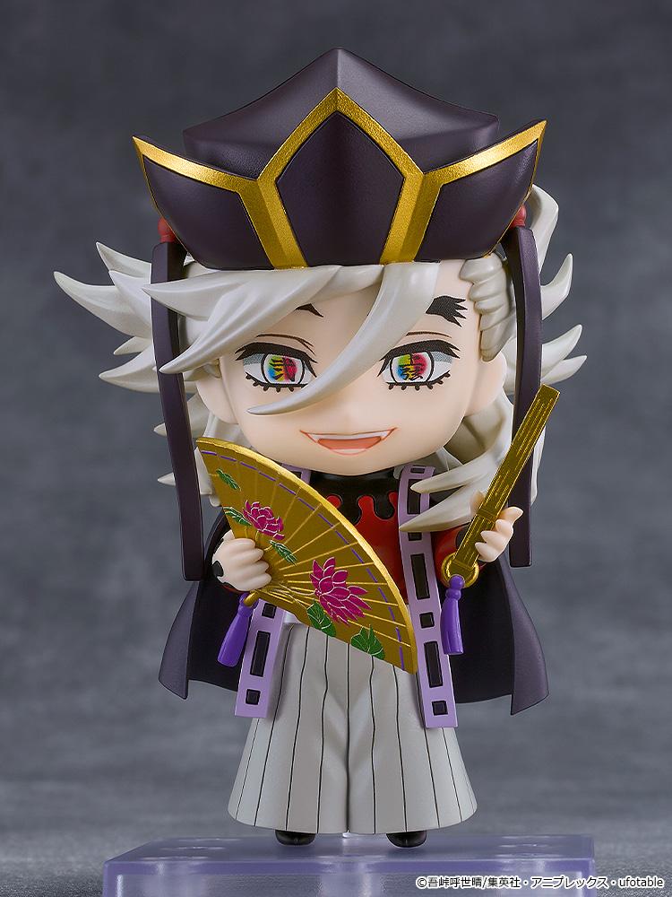 Demon Slayer: Kimetsu no Yaiba Doma Nendoroid figure standing on display base holding gold lotus fans with smiling faceplate.