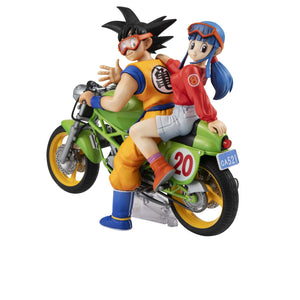 Rear view of the Desktop Real McCoy Dragon Ball Z figure showcasing young adult Son Goku and Chi-Chi riding a green motorcycle.