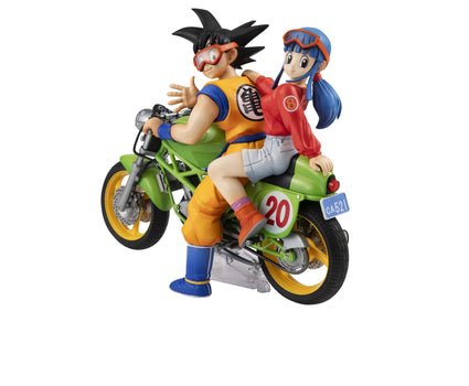 Rear view of the Desktop Real McCoy Dragon Ball Z figure showcasing young adult Son Goku and Chi-Chi riding a green motorcycle.