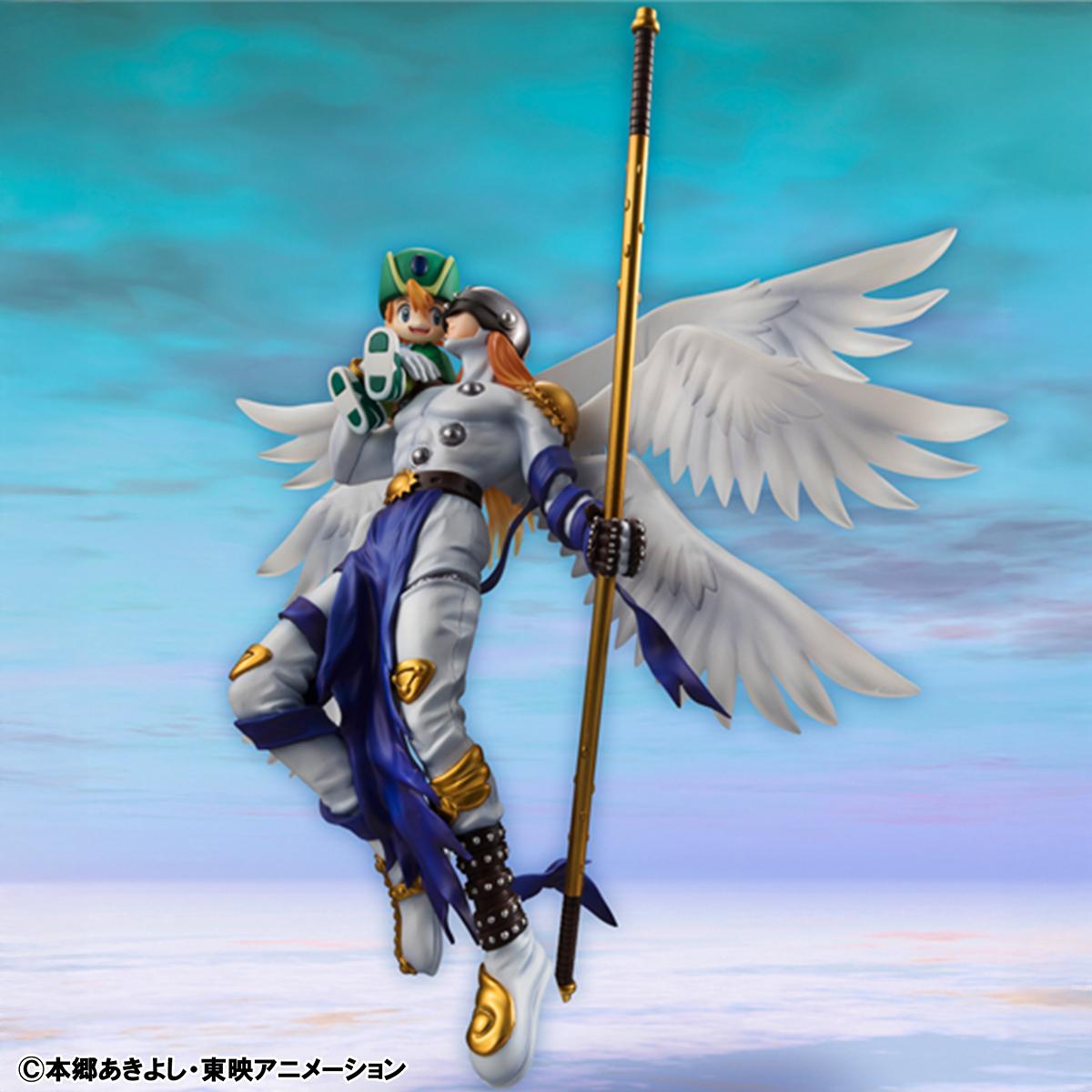 High-angle shot of the non-articulated Angemon figure showcasing his muscular physique and long golden staff.