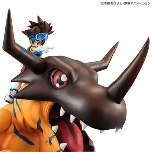 Close-up shot of Greymon's brown helmeted head and open jaw with Tai Yagami pointing forward