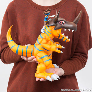 In-hand photo demonstrating the large 25cm size and scale of the Megahouse Precious G.E.M. Greymon figure