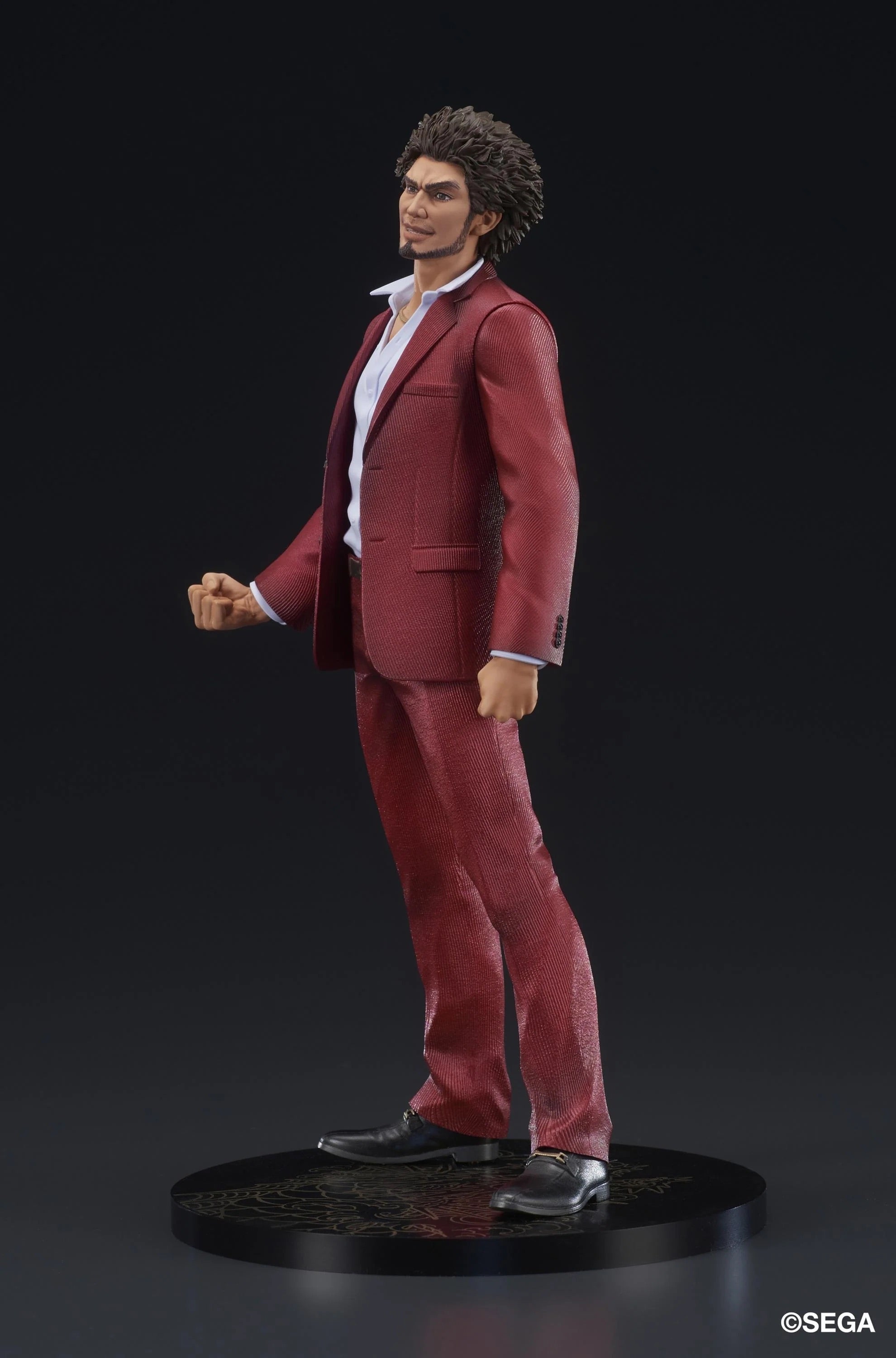 Side profile of the Ichiban Kasuga figure in his red suit, highlighting the determined expression and pose.
