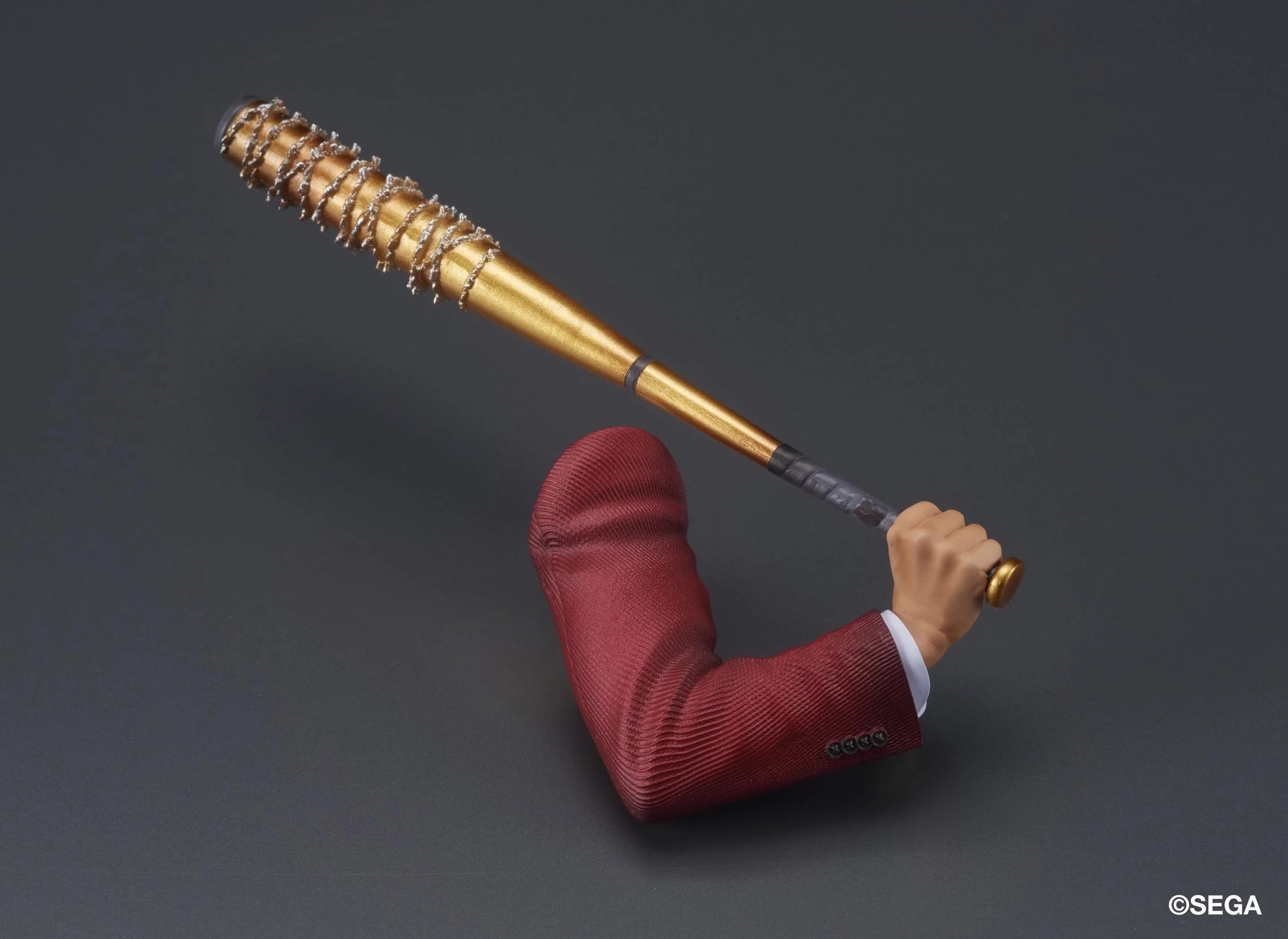 A detailed shot of the interchangeable arm accessory for the Ichiban Kasuga figure, holding the spiked golden Hero's Bat.