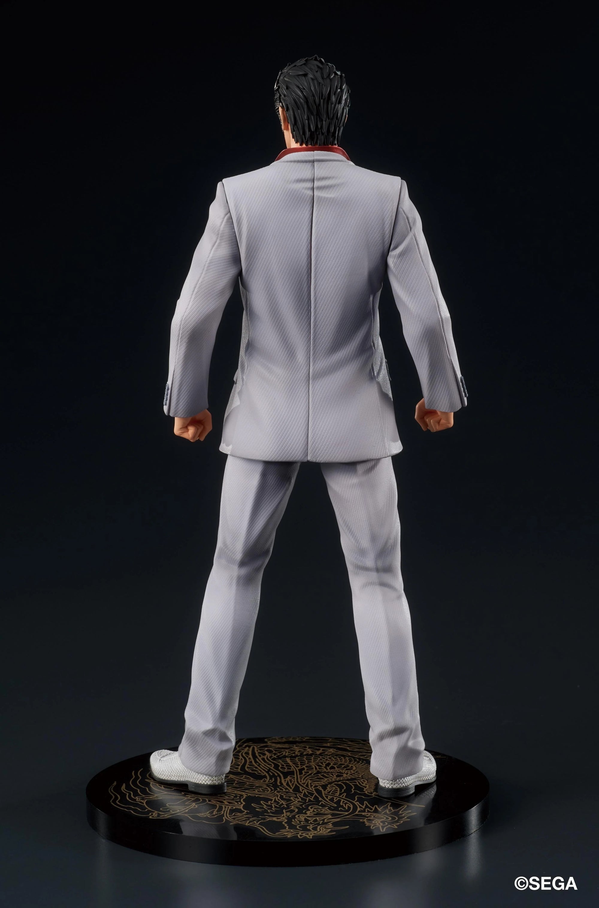 Rear view of the Kazuma Kiryu figure, highlighting the fit of his gray suit and the golden Oryu dragon pattern on the display base.