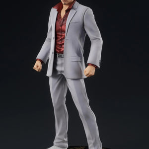 A three-quarter front view of the Kazuma Kiryu figure, showcasing his determined expression and the sharp tailoring of his gray suit.