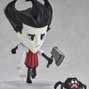 Nendoroid Wilson figure posed holding the axe, standing next to the small, dark spider enemy accessory.