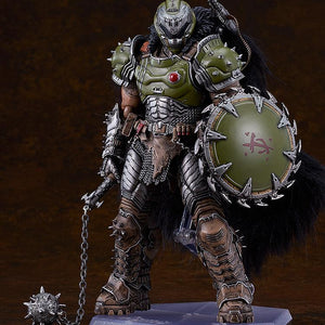 Full-body studio shot of the deluxe Doom Slayer figma standing on a clear display base, holding his spiked flail accessory against a dark brown background.