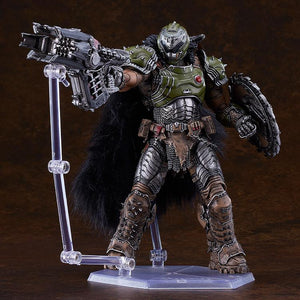 Doom Slayer DX edition figma pointing the large, detailed skull crusher firearm accessory, stabilized by an articulated clear display stand.