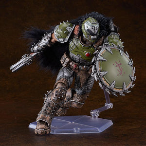 Articulated Doom Slayer figma action figure dynamically posed mid-run with his chain shield raised forward and super shotgun extended behind him.
