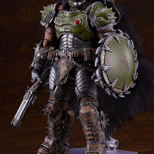 Full-body studio shot of the highly detailed Doom Slayer figma figure standing on a clear hexagonal display base against a dark brown gradient background.