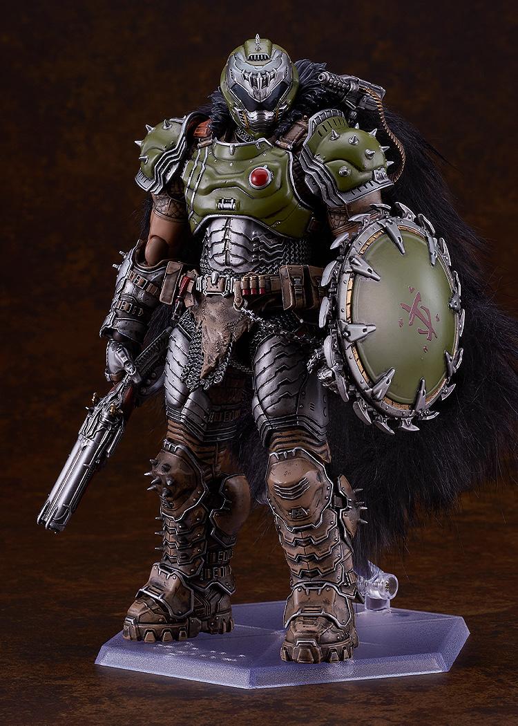 Full-body studio shot of the highly detailed Doom Slayer figma figure standing on a clear hexagonal display base against a dark brown gradient background.