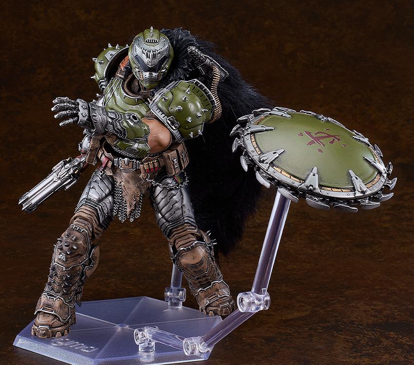 Doom Slayer figma figure demonstrating the chain shield accessory mounted on a separate clear support arm to simulate a throwing or spinning action.