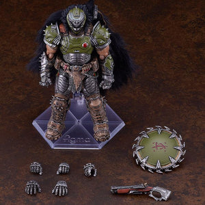 Overhead studio layout of the figma Doom Slayer figure alongside its complete accessories, including five interchangeable hands, the super shotgun, and the circular chain shield.