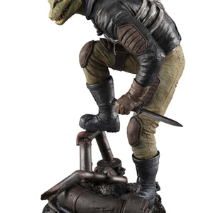 Side profile view of the Caiman figure with his bare reptilian head, highlighting the spiked crest and textured leather jacket.