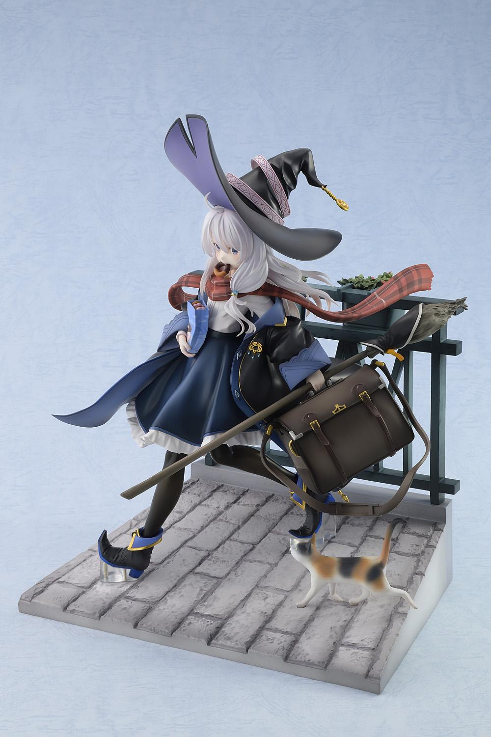 Front left three-quarter angle view of the Elaina 1/7 scale figure showcasing her dynamic stride, large brown travel bag, and witch's broom on a cobblestone path.