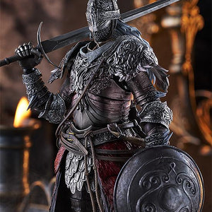 Atmospheric close-up portrait of the figma Raging Wolf figure clad in detailed iron armor, resting his bastard sword on his shoulder and holding his roundshield against a warm candlelit background.