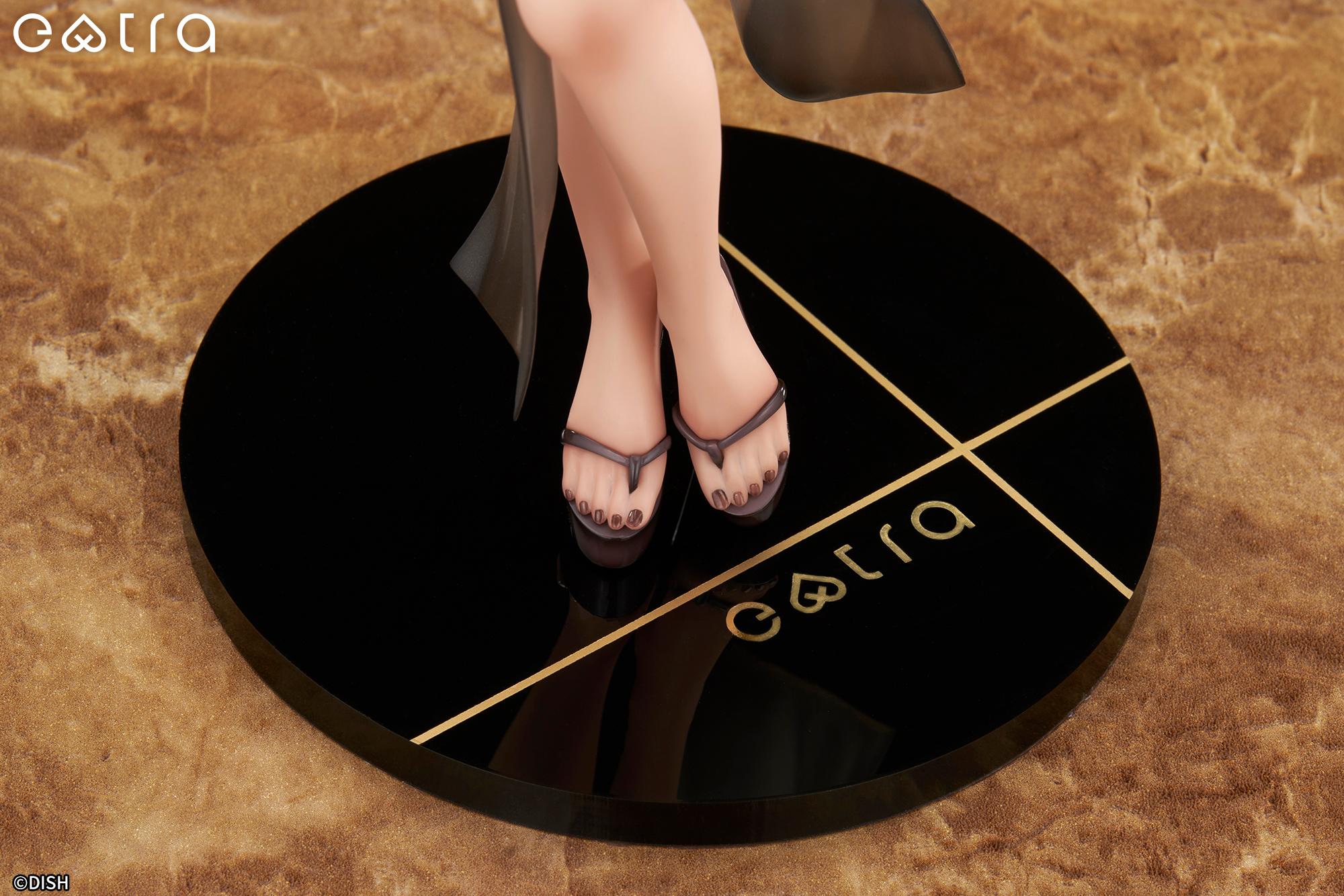 Close-up of the Lilith figure's feet wearing platform sandals with painted toenails, standing on a black circular base with a gold 'extra' logo.
