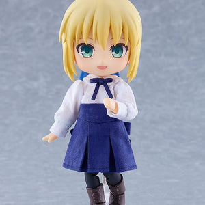 Full-body standing view of the Fate/Stay Night Saber Nendoroid Doll figure in her casual white top and blue skirt on a magnetic base.