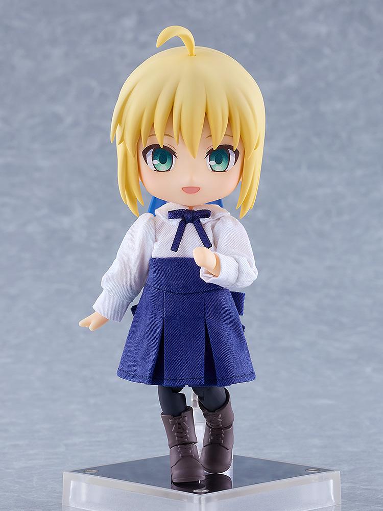 Full-body standing view of the Fate/Stay Night Saber Nendoroid Doll figure in her casual white top and blue skirt on a magnetic base.