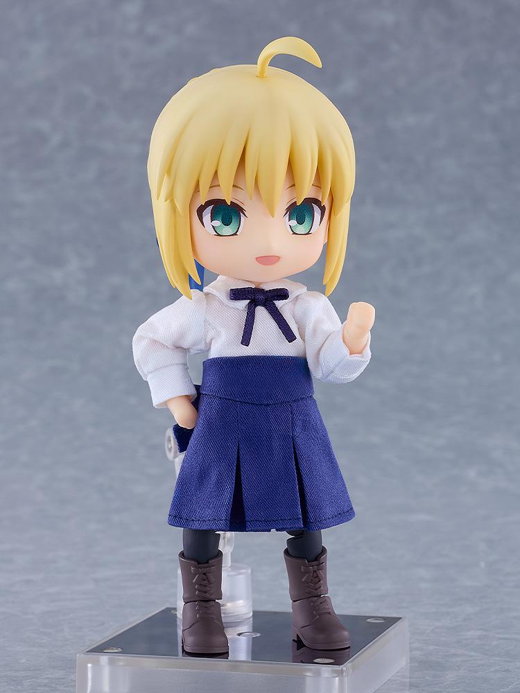 Saber Nendoroid Doll figure from Fate/Stay Night standing with a raised fist while wearing her fabric casual outfit.