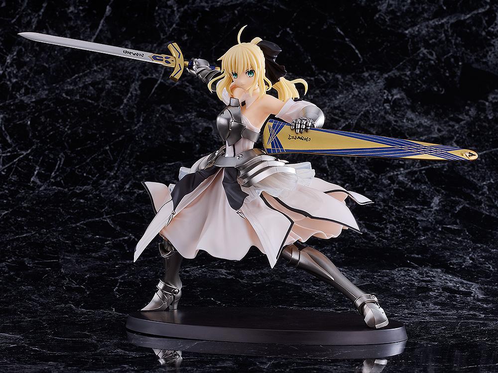 Front view of the Saber Lily (Distant Avalon) plastic model kit displaying her billowing dress and swords on a black marble background.